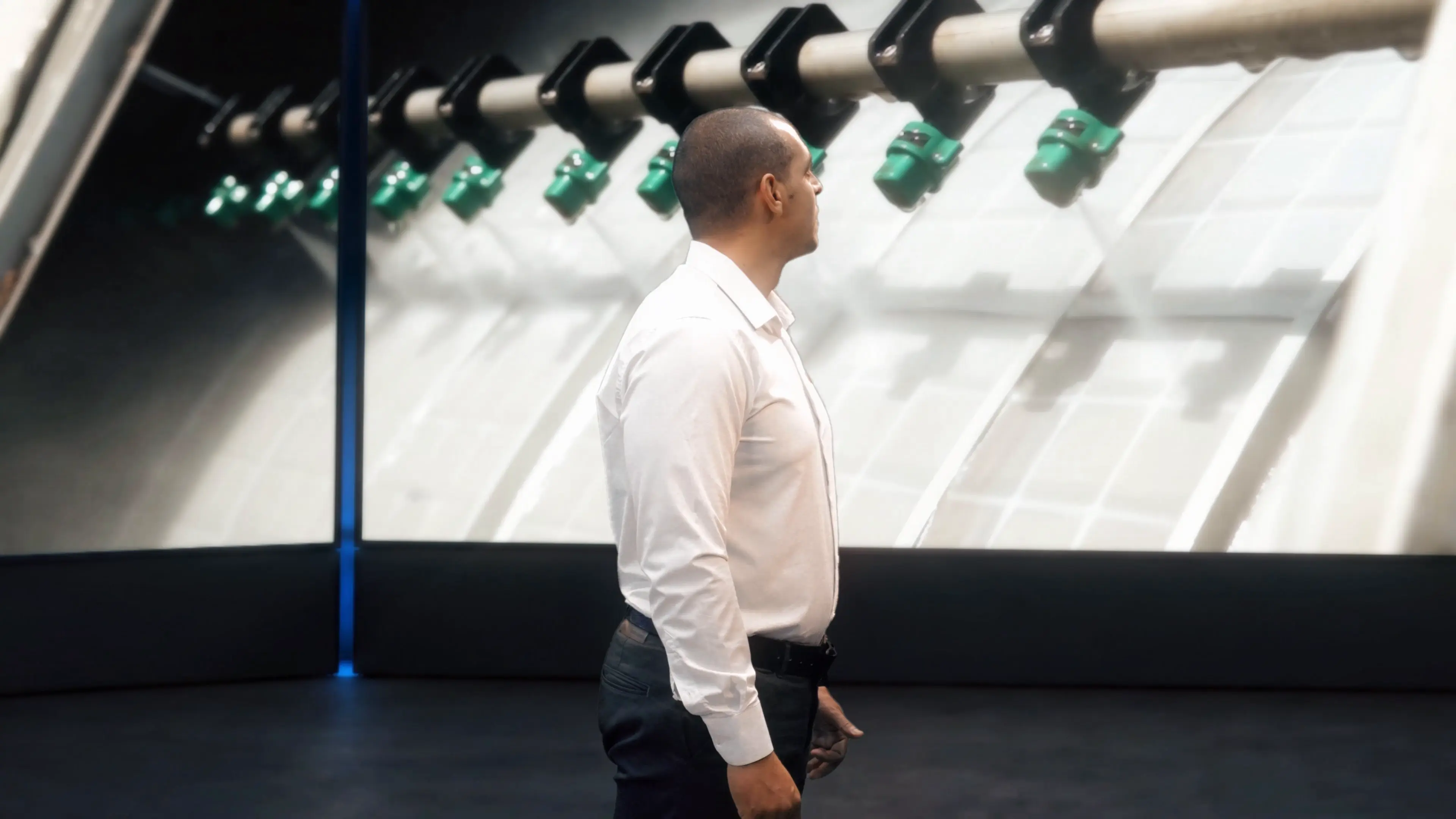 Profile of a Veolia singer facing industrial imagery across the virtual screens
