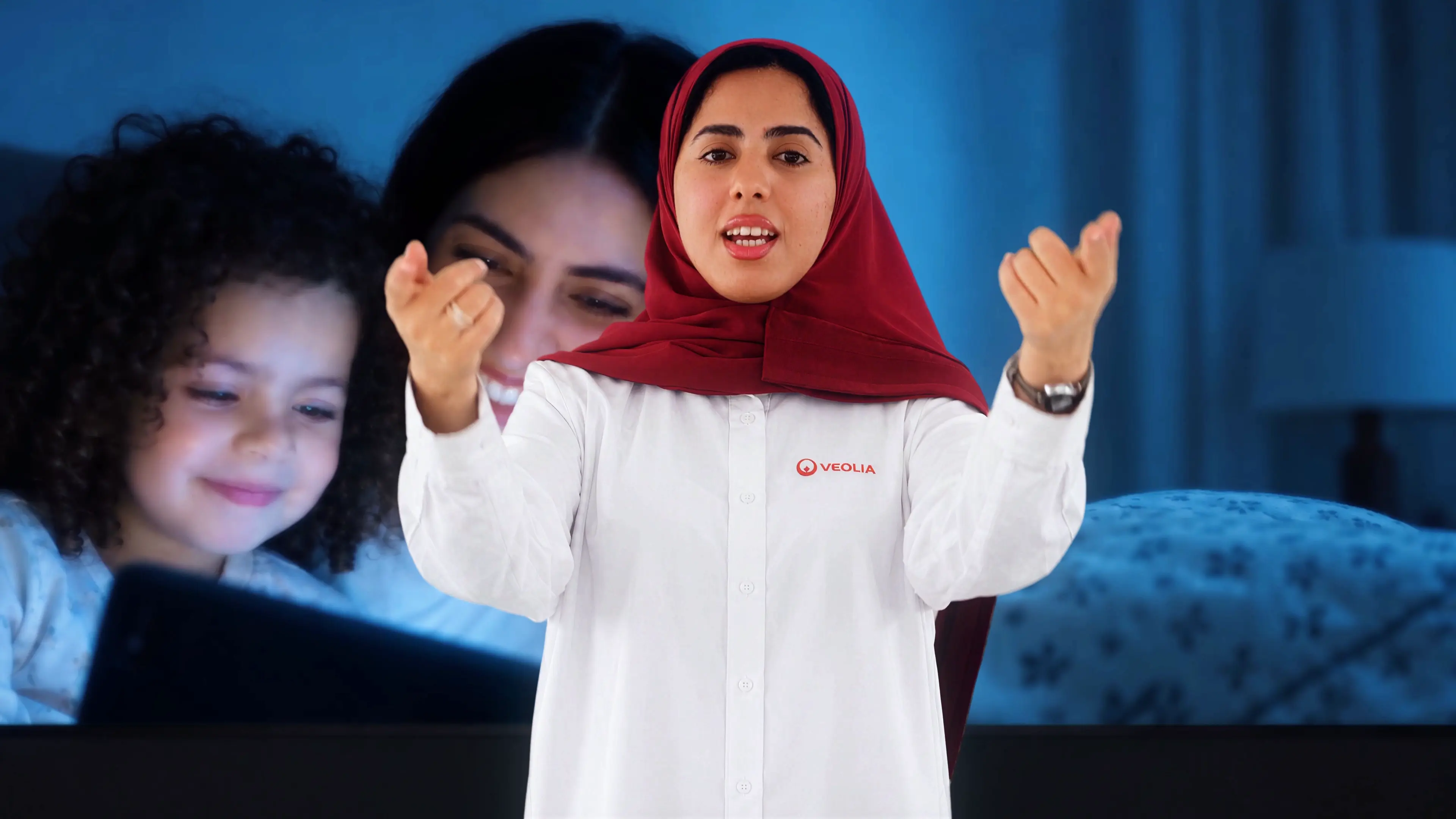 Veolia performer in a red headscarf framed against a family story